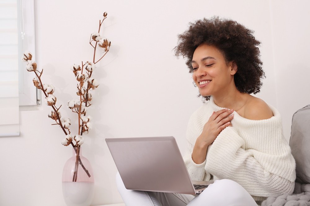 Communication and Connection during Coronavirus lockdown , Self-isolation. Woman using online technology to keep in touch with Friends and Family. Good news and Gratitude concept