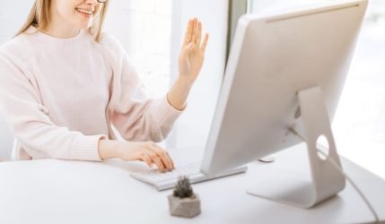 businesswoman sitting at her workplace and having video chat with boyfriend